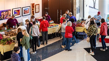 Bird's-eye view of people shopping at indoor Holiday Farmers Market