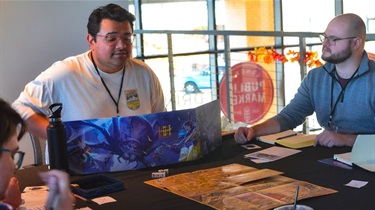 Group focused on game in center of table