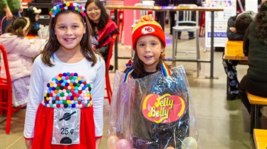 One girl dressed as a jelly bean and one girl dressed as a gumball machine for Halloween costume contest