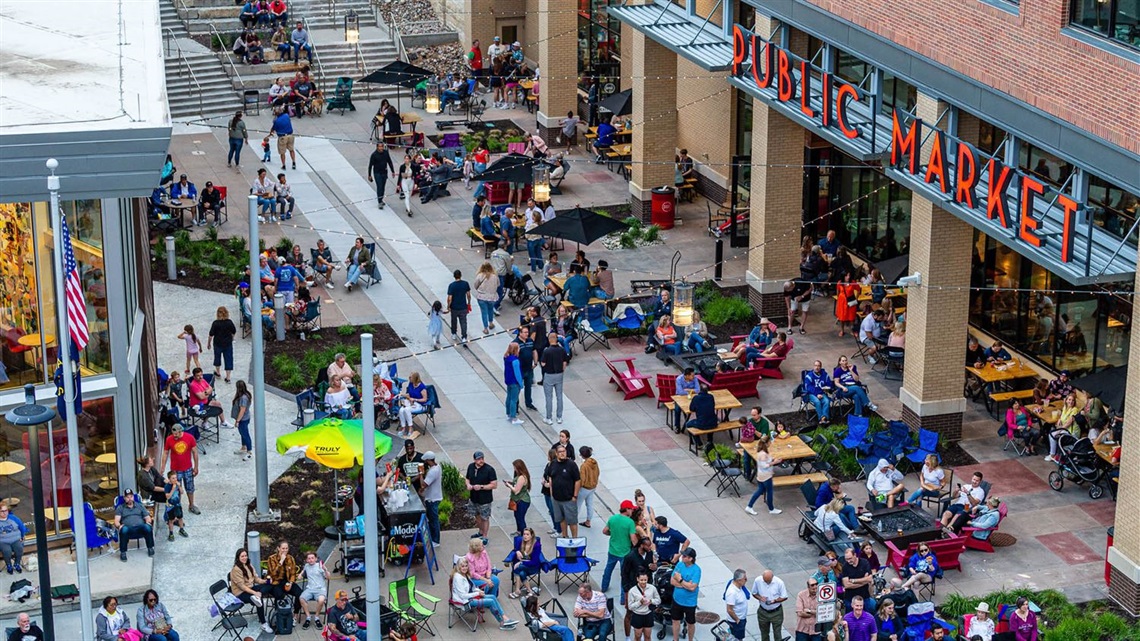 Crowd of people watching band outside the Lenexa Public Market.