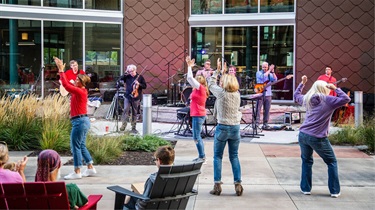 Couple dancing in front of band performing outside the Public Market