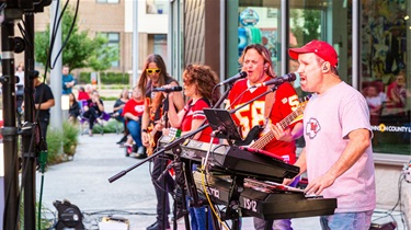 Band singing and wearing Kansas City Chiefs apparel