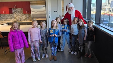 Santa with a group of Girl Scouts in The Kitchen