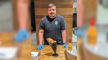 Owner of Una Mas Empanadas serving in the Public Market