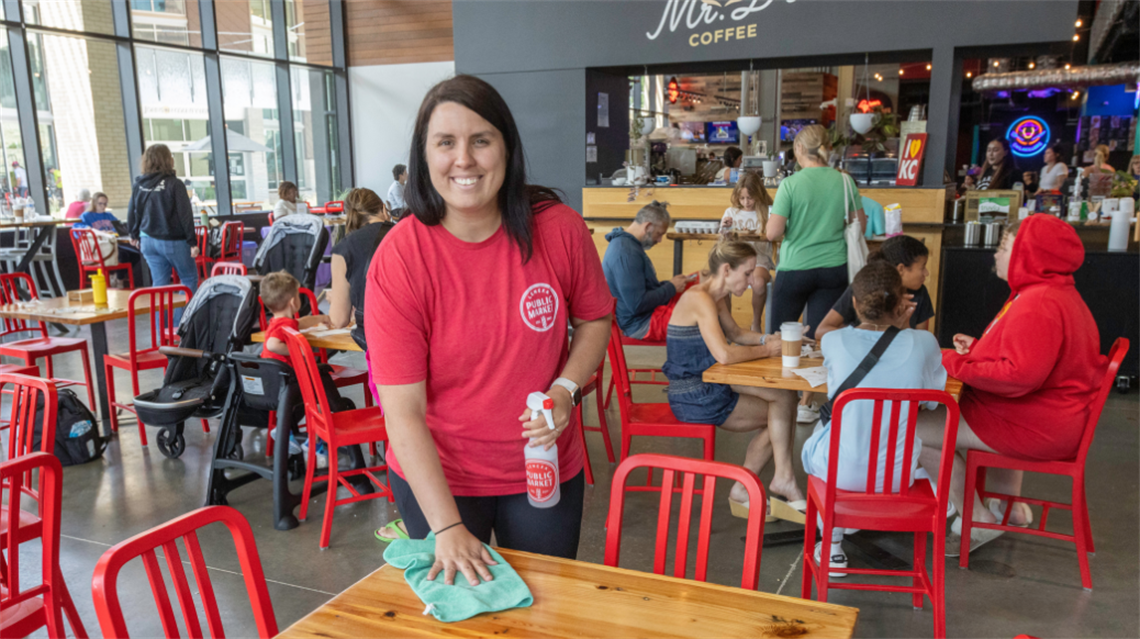 Public Market Concierge cleaning table inside the Lenexa Public Market.