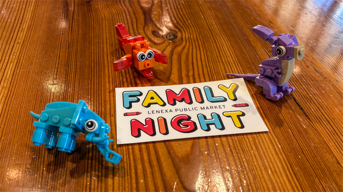 Family Night sticker on wooden table with three examples of build a buddy elephant, kangaroo and fish