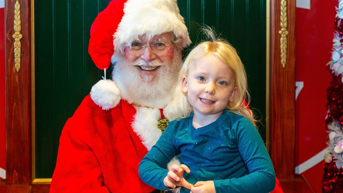 Young girl with Santa smiling